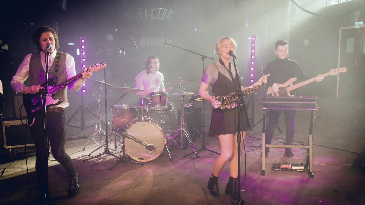 The Paris Syndrome playing on stage under warm light
